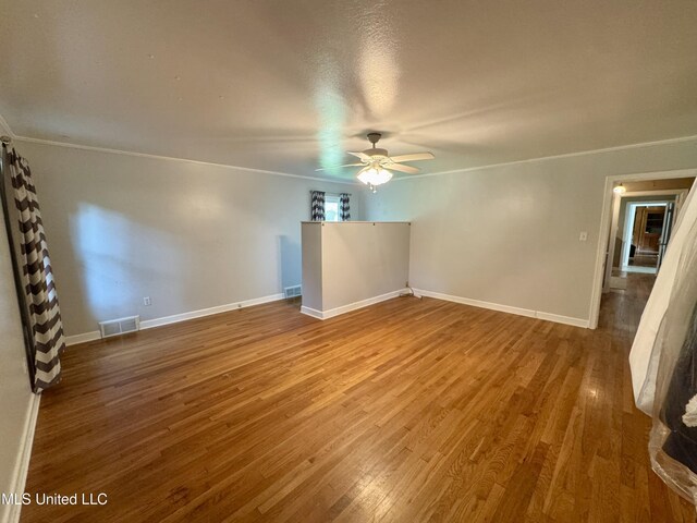 2293 Elm St, Hernando, MS 38632 - empty room featuring ceiling fan, wood finished floors, baseboards, and ornamental molding