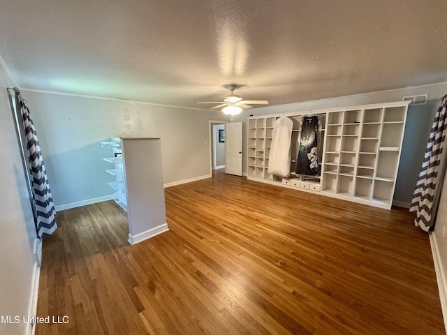 2293 Elm St, Hernando, MS 38632 - unfurnished living room featuring a ceiling fan, wood finished floors, baseboards, ornamental molding, and a textured ceiling