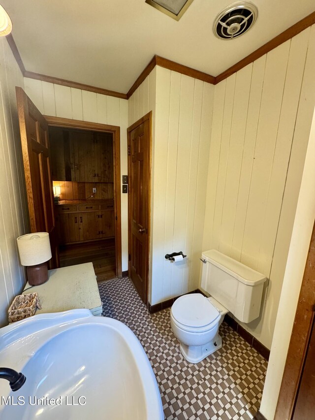 2293 Elm St, Hernando, MS 38632 - bathroom with a sink, crown molding, tile patterned floors, toilet, and wood walls