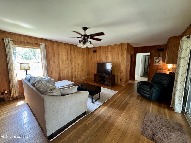 2293 Elm St, Hernando, MS 38632 - living room featuring wood walls, light wood-style floors, and a ceiling fan