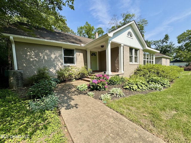 2293 Elm St, Hernando, MS 38632 - view of front of home featuring brick siding, a chimney, and a front lawn