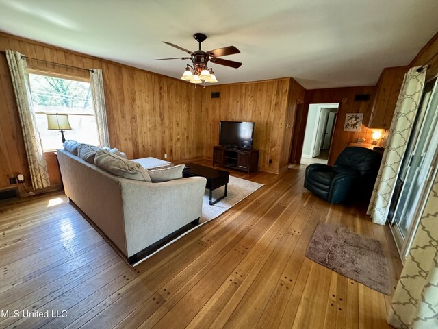 2293 Elm St, Hernando, MS 38632 - living area featuring wooden walls, light wood-style floors, and ceiling fan