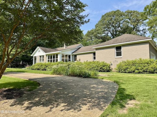 2293 Elm St, Hernando, MS 38632 - ranch-style house featuring a front yard and brick siding