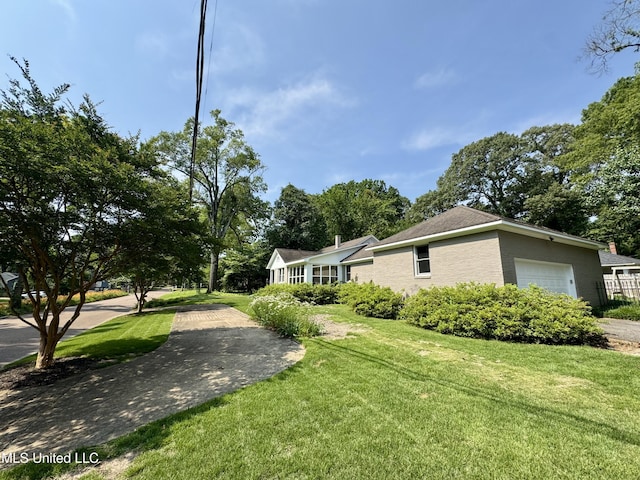 2293 Elm St, Hernando, MS 38632 - view of side of property with a yard and a garage