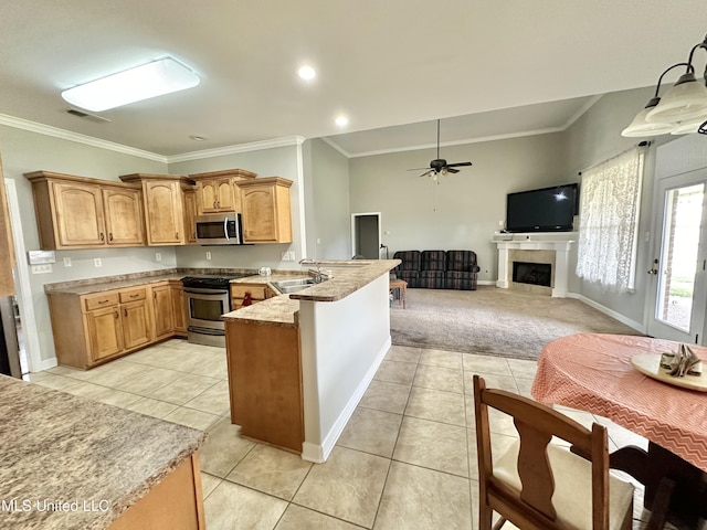 kitchen featuring visible vents, a sink, appliances with stainless steel finishes, a peninsula, and light tile patterned flooring