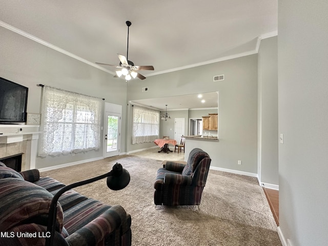 carpeted living area with crown molding, visible vents, baseboards, and a tile fireplace