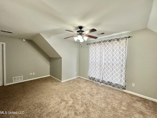 bonus room with visible vents, carpet flooring, and vaulted ceiling