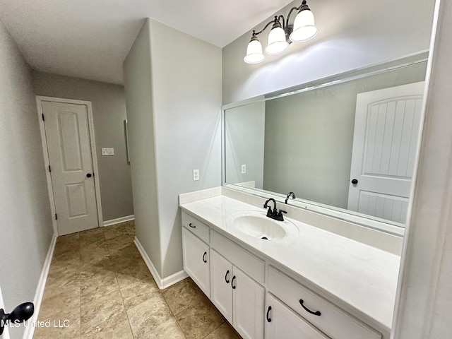 bathroom with baseboards and vanity