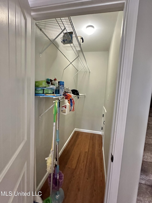 walk in closet with wood finished floors