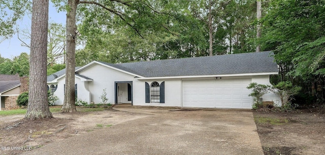 view of front of house with concrete driveway, brick siding, an attached garage, and a shingled roof