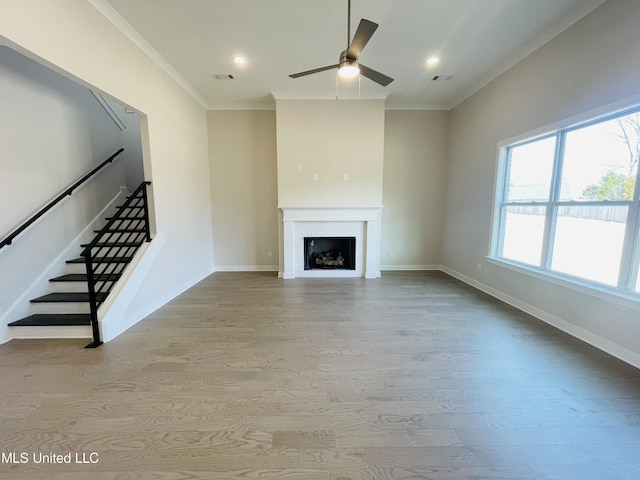 unfurnished living room with ornamental molding, ceiling fan, and light hardwood / wood-style flooring