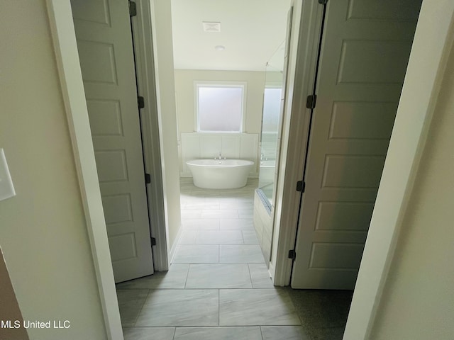 corridor with light tile patterned floors