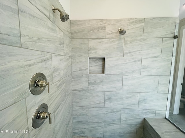 bathroom with a tile shower