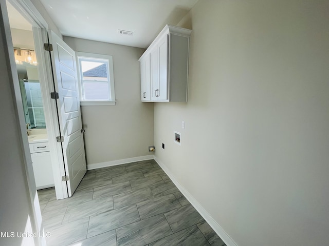 laundry room with cabinets, hookup for an electric dryer, and washer hookup