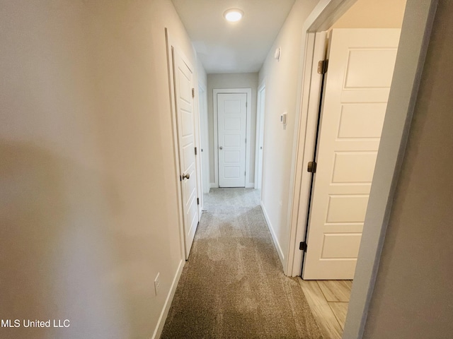 hallway featuring light carpet