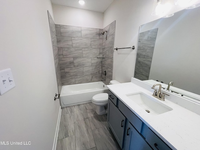 full bathroom with toilet, vanity, and tiled shower / bath combo