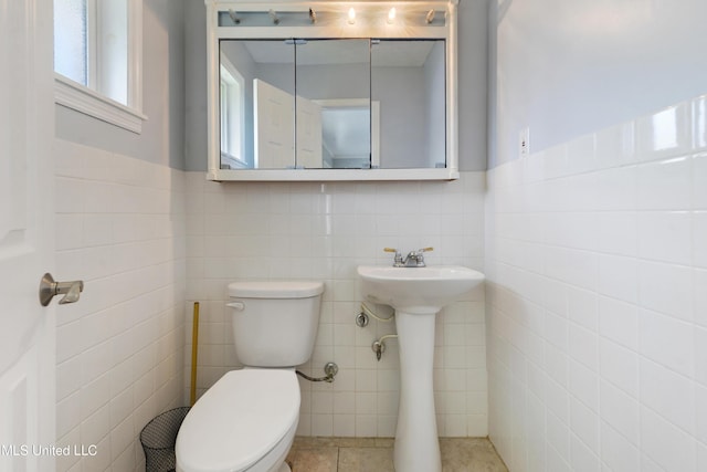 120 Pitcher Pt, Long Beach, MS 39560 - half bath featuring tile walls, toilet, tile patterned floors, and a wainscoted wall