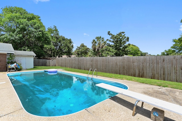 120 Pitcher Pt, Long Beach, MS 39560 - view of swimming pool featuring a fenced backyard, a diving board, and an outdoor structure