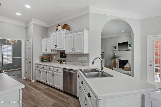 kitchen with dishwasher, a sink, a peninsula, recessed lighting, and white cabinetry
