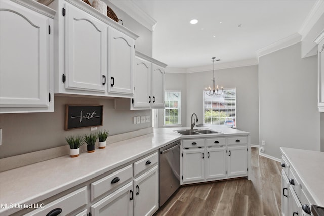 kitchen with white cabinets, crown molding, a sink, dishwasher, and wood finished floors