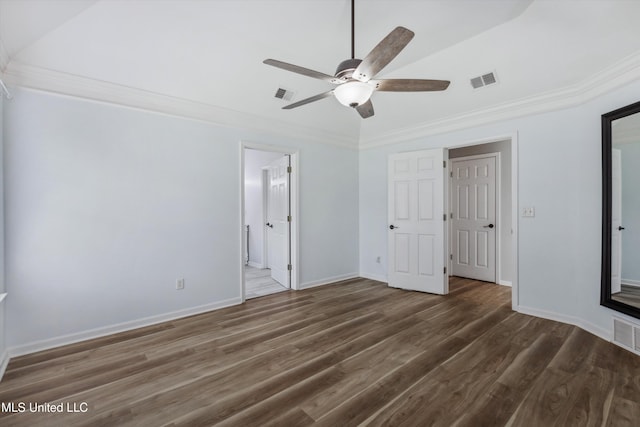 unfurnished bedroom featuring visible vents, baseboards, crown molding, and wood finished floors