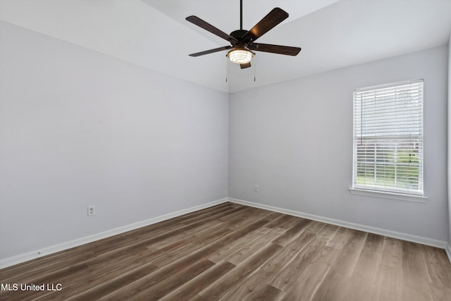 empty room with baseboards, ceiling fan, and wood finished floors