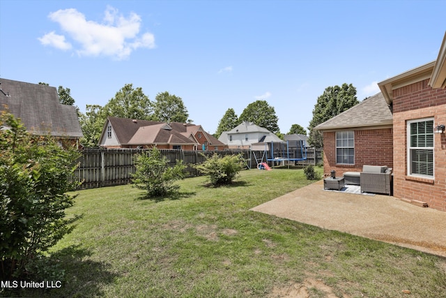 view of yard with an outdoor living space, a trampoline, a residential view, a fenced backyard, and a patio