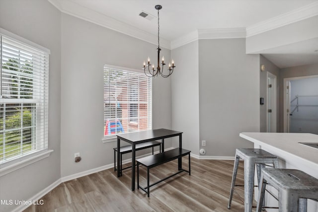 dining space featuring visible vents, light wood-style floors, and a healthy amount of sunlight