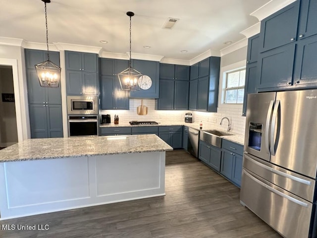 kitchen with tasteful backsplash, visible vents, appliances with stainless steel finishes, a notable chandelier, and a sink