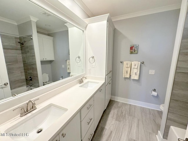 full bathroom featuring a sink, toilet, and crown molding