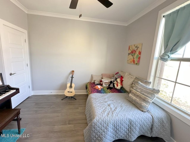 bedroom with ceiling fan, crown molding, baseboards, and wood finished floors