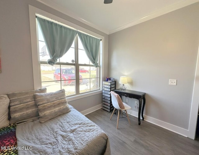 bedroom featuring wood finished floors, baseboards, and ornamental molding