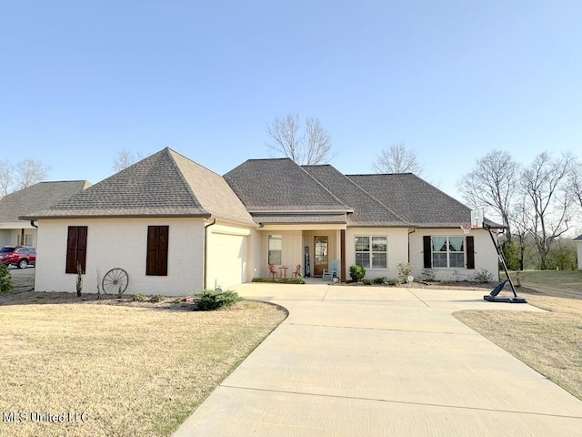 view of front of house featuring concrete driveway, an attached garage, brick siding, and roof with shingles