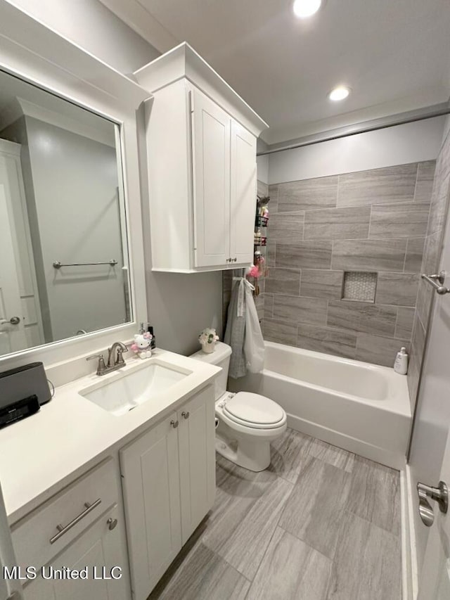 full bath featuring recessed lighting, toilet, vanity, and bathtub / shower combination