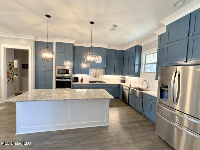 kitchen featuring blue cabinets, a kitchen island, appliances with stainless steel finishes, and a sink