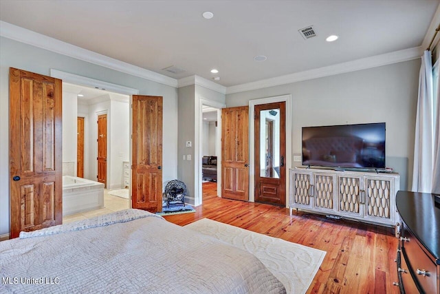 bedroom featuring ensuite bath, crown molding, and light wood-type flooring