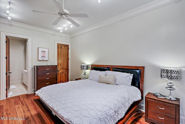 bedroom with ceiling fan, ensuite bathroom, track lighting, and light wood-type flooring