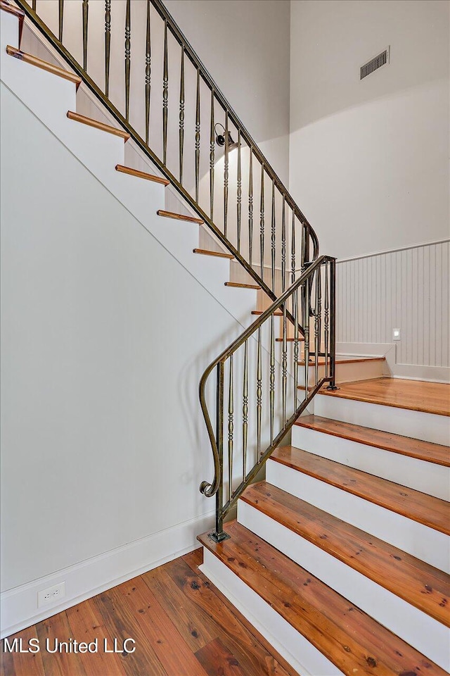 stairs featuring hardwood / wood-style flooring