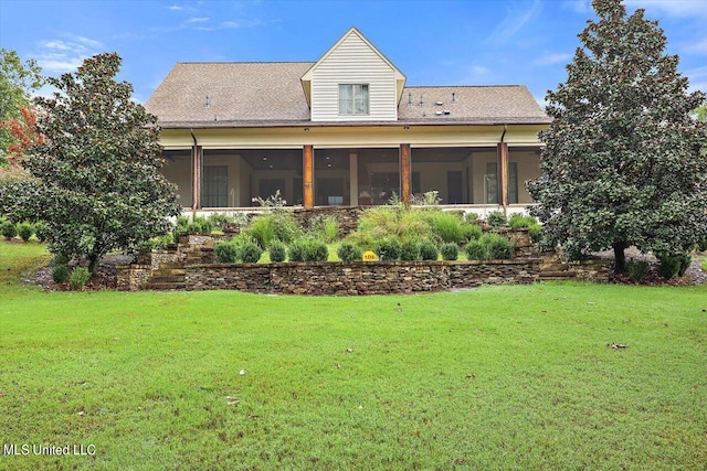 rear view of property featuring a sunroom and a yard