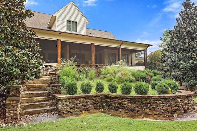 rear view of house with a sunroom