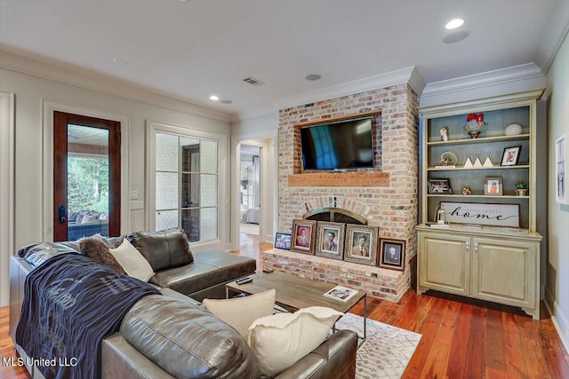 living room featuring wood-type flooring and ornamental molding