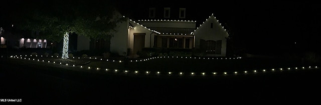 view of back house at twilight