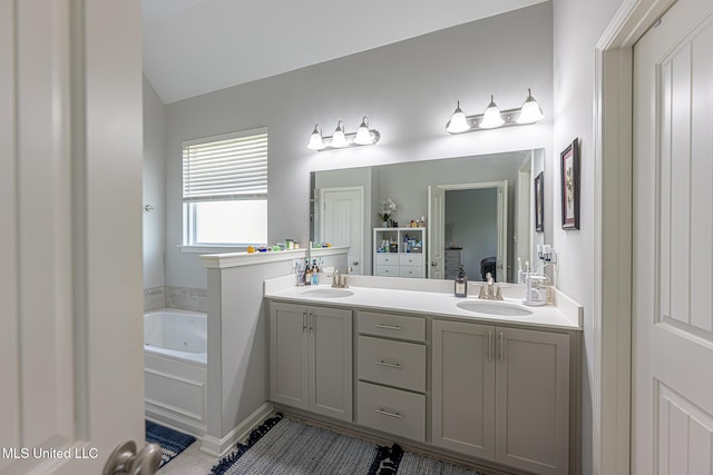 6750 Whooper Swan Dr, Olive Branch, MS 38654 - bathroom featuring double vanity, a whirlpool tub, tile patterned flooring, and lofted ceiling