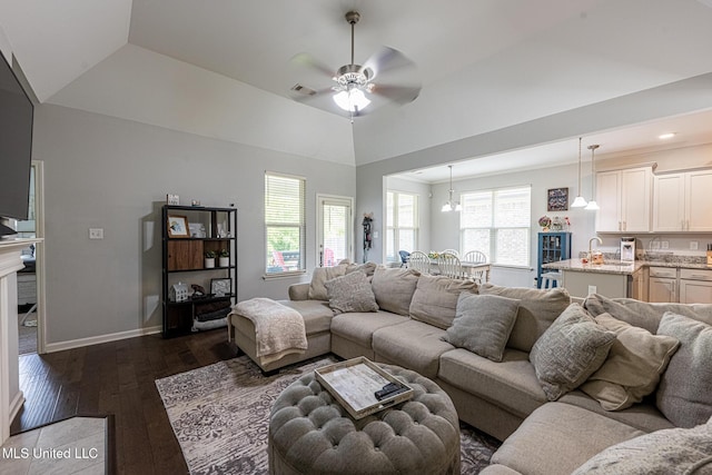 6750 Whooper Swan Dr, Olive Branch, MS 38654 - living area featuring dark wood-style flooring, a ceiling fan, vaulted ceiling, and baseboards
