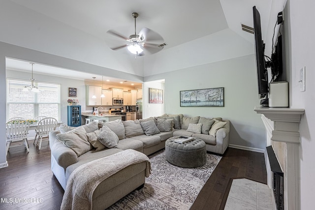 6750 Whooper Swan Dr, Olive Branch, MS 38654 - living room featuring a ceiling fan, dark wood-style flooring, baseboards, and a towering ceiling
