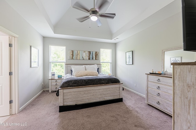 6750 Whooper Swan Dr, Olive Branch, MS 38654 - bedroom featuring light carpet, a tray ceiling, baseboards, and ceiling fan
