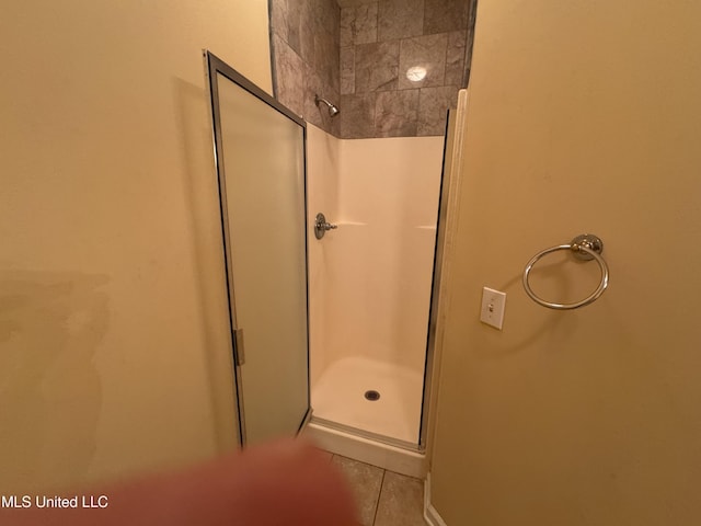 bathroom with tile patterned flooring and walk in shower