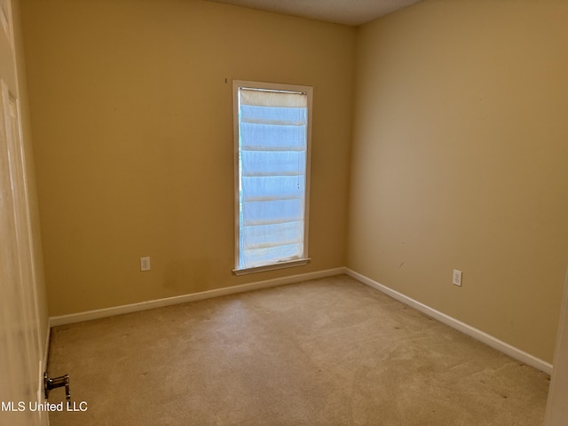 empty room featuring light carpet