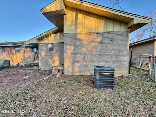 rear view of house featuring central air condition unit