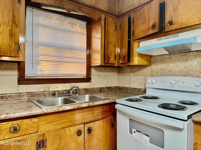 kitchen with decorative backsplash, electric range, and sink